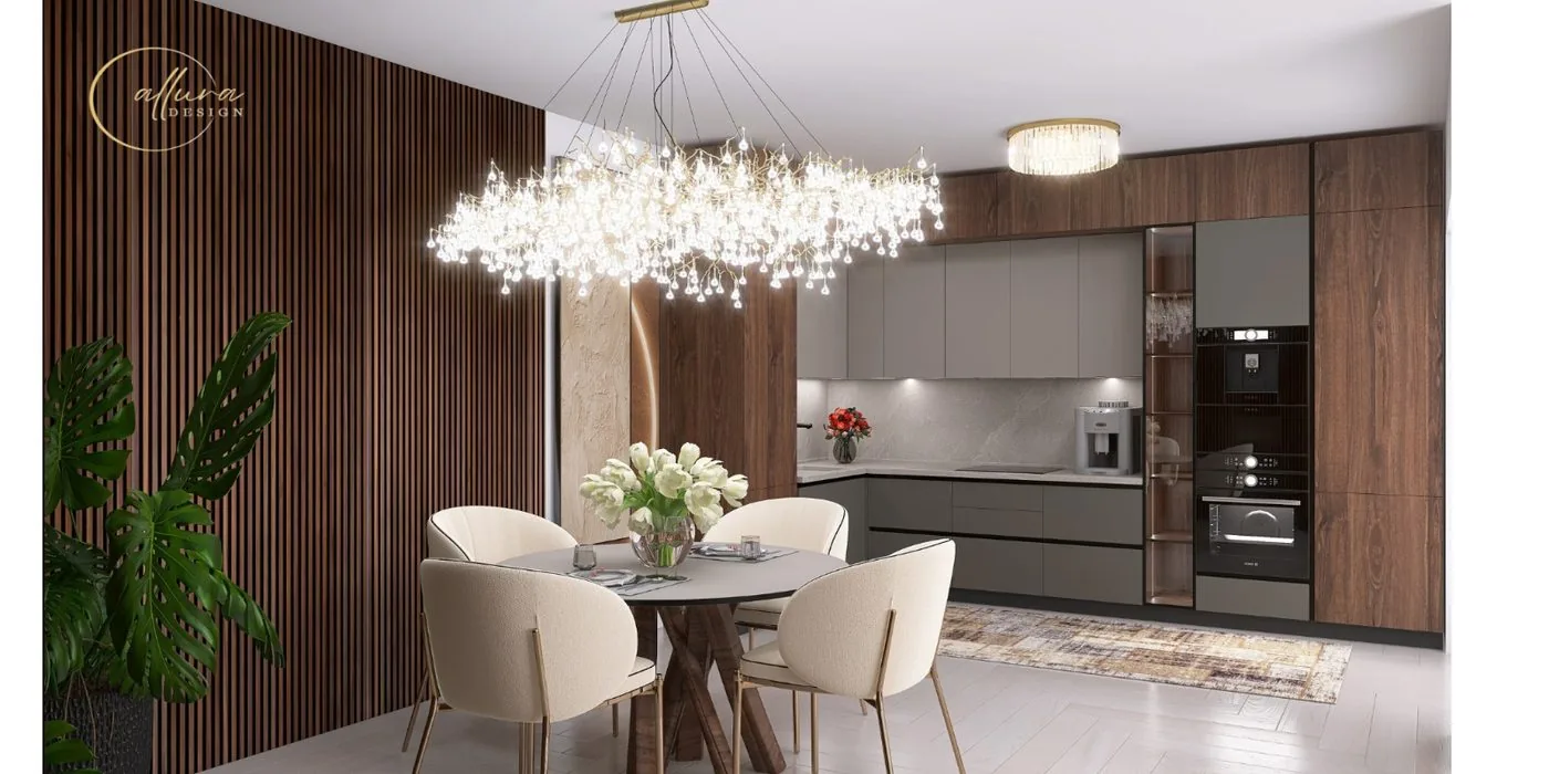 Masă rotundă sub un candelabru de cristal, cu bucătăria în fundal